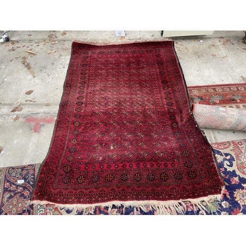 2490 - A SMALL RED PATTERNED FRINGED RUG