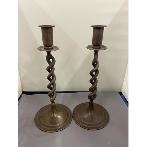 30 - A PAIR OF TWISTED BRONZE CANDLESTICKS