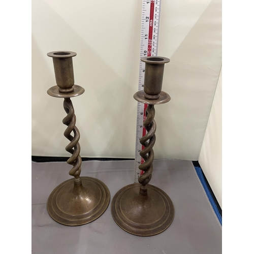 30 - A PAIR OF TWISTED BRONZE CANDLESTICKS