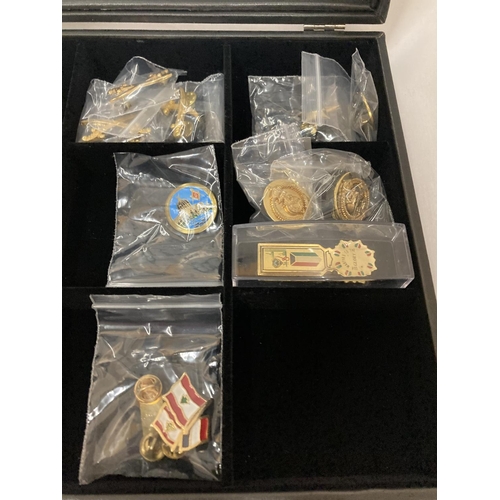 392 - A DISPLAY CASE CONSTAINING TWENTY FIVE GULF MEDALS AND BADGES INCLUDING A PAIR OF SAUDI ARMY EPAULET... 