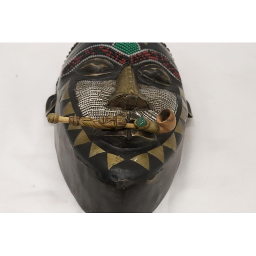 464 - AN AFRICAN TRIBAL MASK, 29CM X 15CM PLUS A VINTAGE HANDMADE TRIBAL WOODEN PIPE