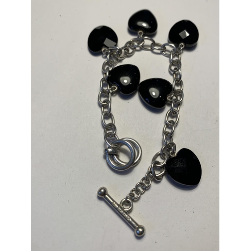 553 - TWO SILVER BRACELETS WITH CHARMS