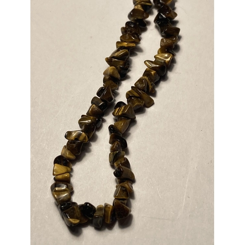 588 - TWO TIGERS EYE NECKLACES ONE WITH PENDANT ON A MARKED SILVER CHAIN