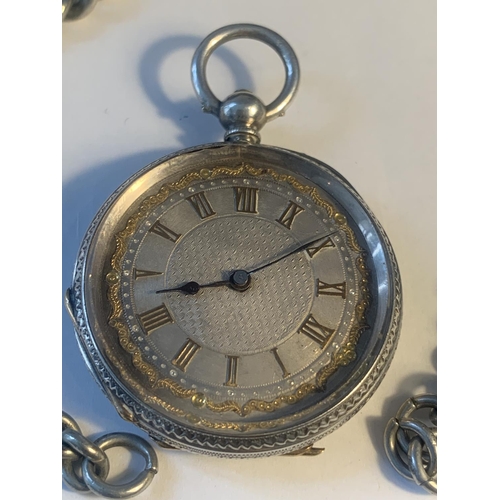 635 - A MARKED FINE SILVER POCKET WATCH WITH DECORATIVE FACE AND A CHAIN