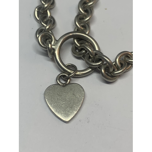 688 - A SILVER T BAR BRACELET WITH HEART CHARM