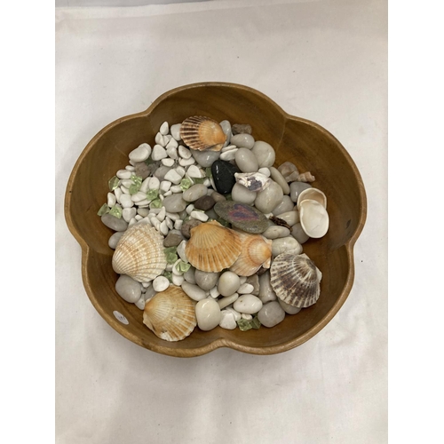 1090 - A WOODEN BOWL CONTAINING SHELLS AND PEBBLES