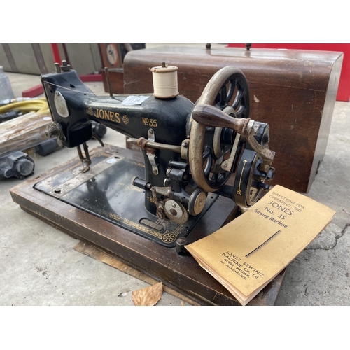 1734 - A VINTAGE JONES SEWING MACHINE WITH WOODEN CARRY CASE