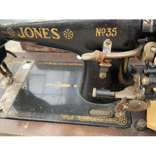 1734 - A VINTAGE JONES SEWING MACHINE WITH WOODEN CARRY CASE