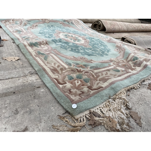 2497 - A GREEN PATTERNED FRINGED RUG