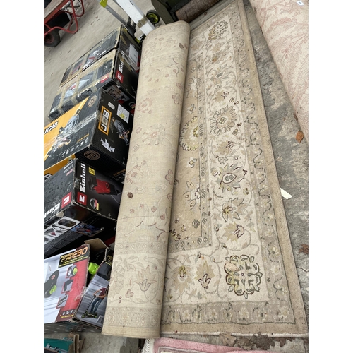 2500 - A LARGE CREAM PATTERNED RUG