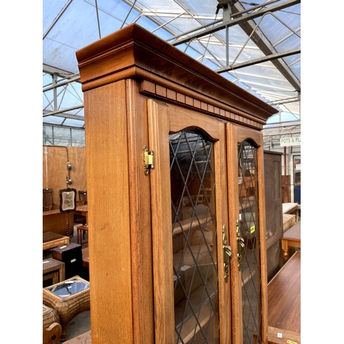 2716 - A MODERN BEECH CORNER CUPBOARD WITH GLAZED AND LEADED UPPER PORTION