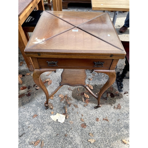 2762 - A LATE VICTORIAN MAHOGANY ENVELOPE CARD TABLE WITH SINGLE DRAWER AND UNDER SHELF