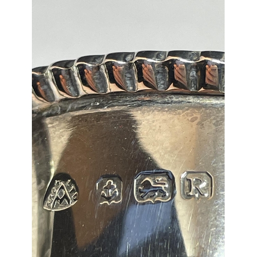 12 - A HALLMARKED BIRMINGHAM SILVER THREE LEGGED SAUCE BOAT