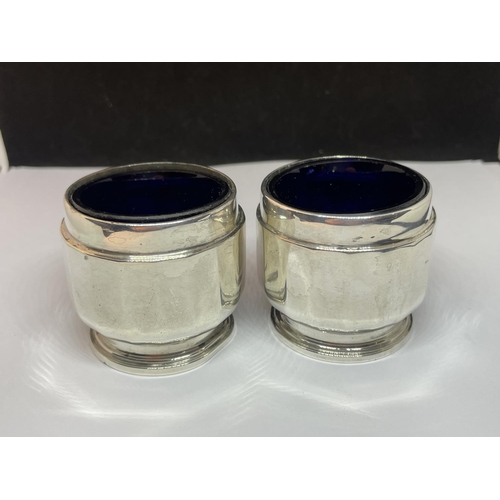 63 - A PAIR OF HALLMARKED BIRMINGHAM SILVER SALTS WITH BLUE GLASS LINERS