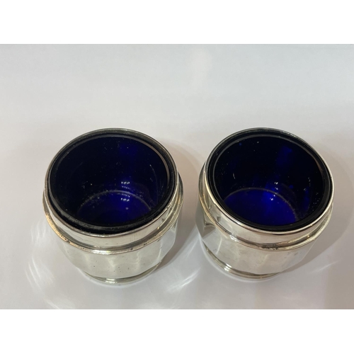 63 - A PAIR OF HALLMARKED BIRMINGHAM SILVER SALTS WITH BLUE GLASS LINERS