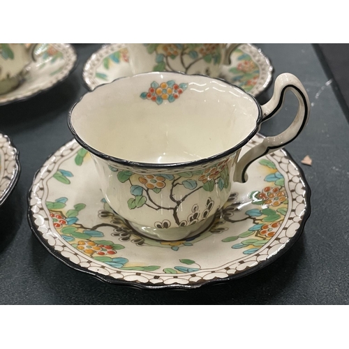 103 - A VINTAGE SET OF SIX ROYAL DOULTON CUPS AND SAUCERS, REG NO. 702852