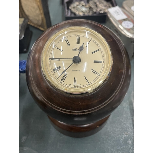 120 - A BOWLING BALL CLOCK ON A WOODEN STAND, HEIGHT 13CM