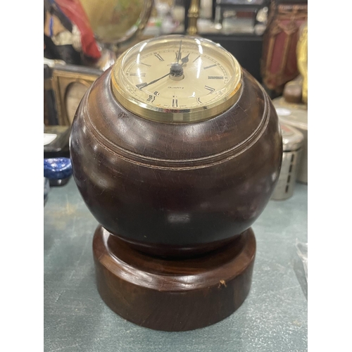 120 - A BOWLING BALL CLOCK ON A WOODEN STAND, HEIGHT 13CM