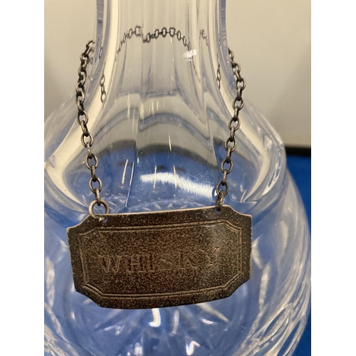 16 - A GLASS DECANTER WITH A HALLMARKED BIRMINGHAM SILVER WHISKY LABEL