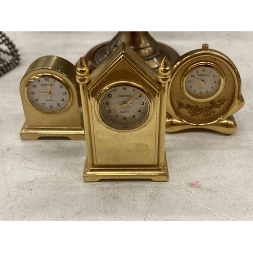 162 - THREE MINIATURE BRASS CLOCKS, HEIGHT APPROX 6CM, PLUS A SMALL ARMILLARY SPHERE ON A WOODEN BASE, HEI... 