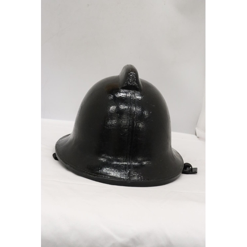 176 - A BLACK VINTAGE FIREMAN'S HELMET