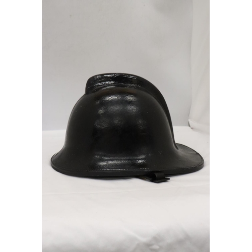 176 - A BLACK VINTAGE FIREMAN'S HELMET