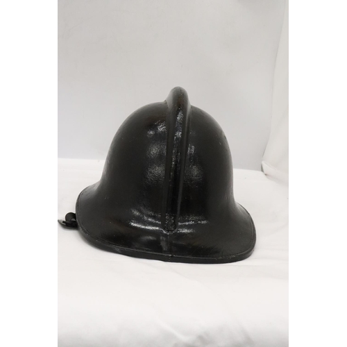 176 - A BLACK VINTAGE FIREMAN'S HELMET