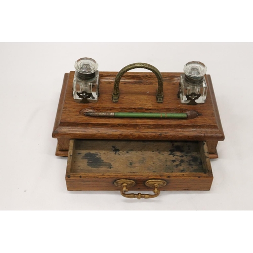 177 - A VINTAGE OAK DESKSET WITH BRASS HANDLE AND DRAWER WITH GLASS INKWELLS