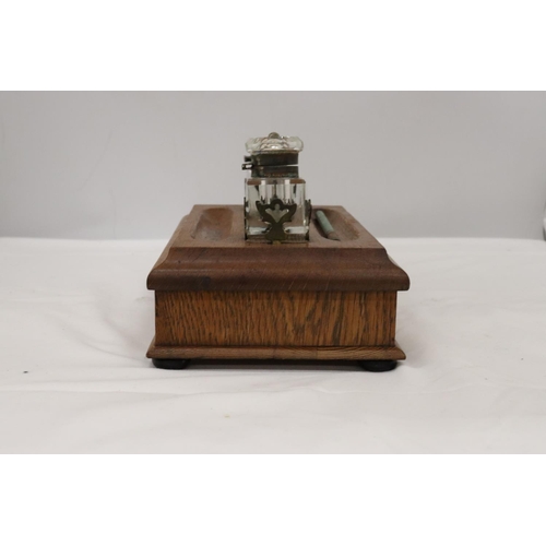 177 - A VINTAGE OAK DESKSET WITH BRASS HANDLE AND DRAWER WITH GLASS INKWELLS