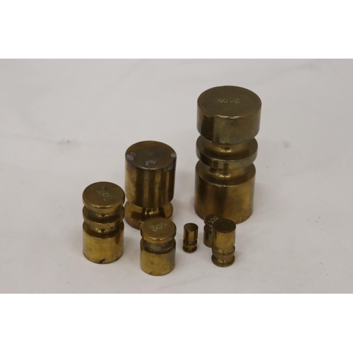 179 - A SET OF BRASS WEIGHTS