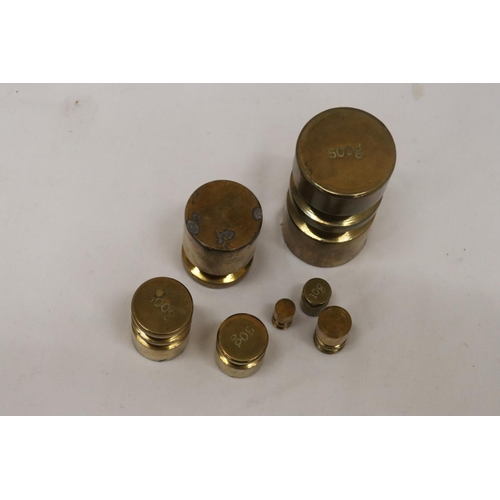 179 - A SET OF BRASS WEIGHTS