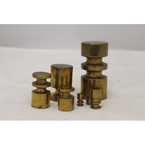 179 - A SET OF BRASS WEIGHTS