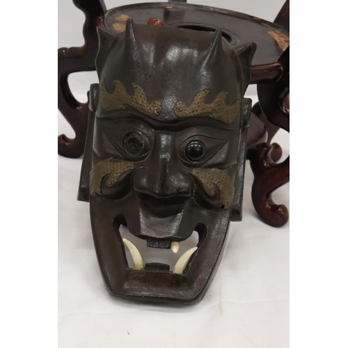 218 - A LARGE WOODEN CHINESE CARVED PEDESTAL TOGETHER WITH A VINTAGE WOODEN MASK