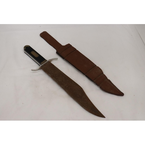 227 - A LARGE VINTAGE DAGEE IN LEATHER SHEATH