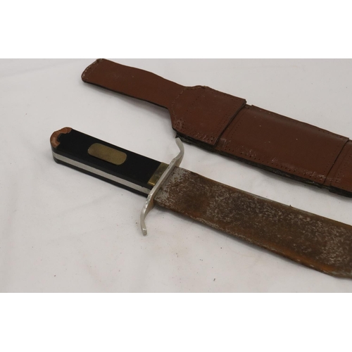 227 - A LARGE VINTAGE DAGEE IN LEATHER SHEATH