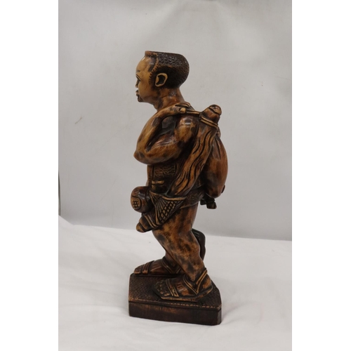 235 - A LARGE HAND CARVED WOODEN HUNTER GATHERER