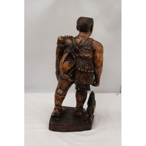 235 - A LARGE HAND CARVED WOODEN HUNTER GATHERER