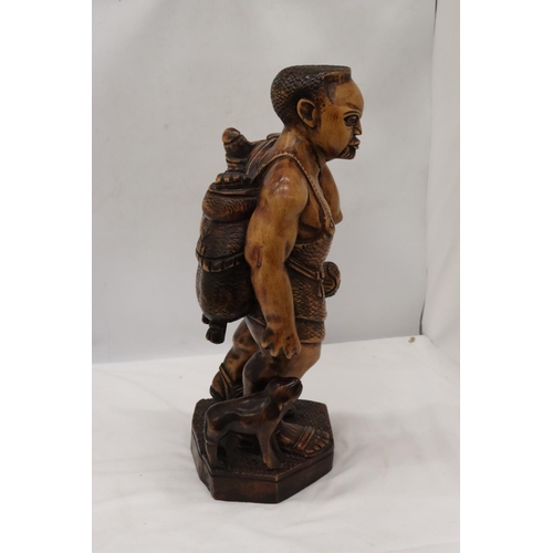 235 - A LARGE HAND CARVED WOODEN HUNTER GATHERER