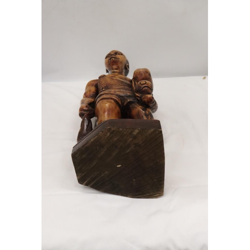 235 - A LARGE HAND CARVED WOODEN HUNTER GATHERER