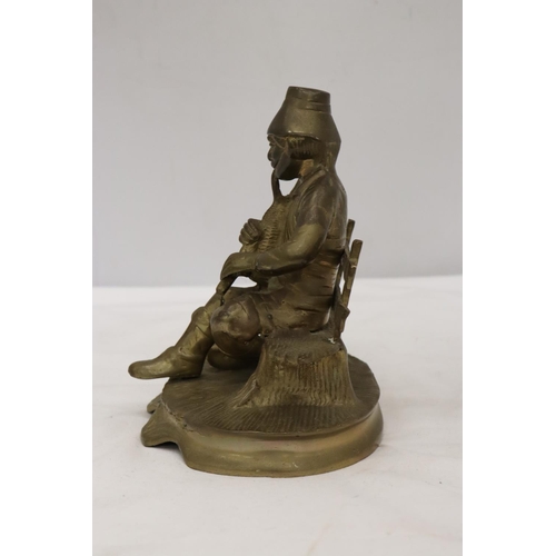 295 - A BRASS SEATED MUSICIAN