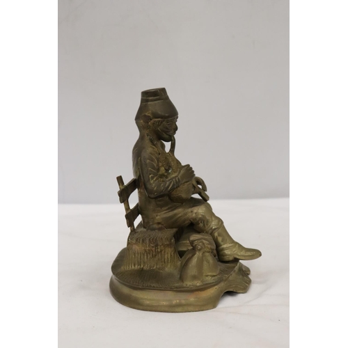 295 - A BRASS SEATED MUSICIAN