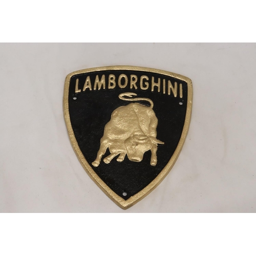 297 - A TRIANGULAR BLACK AND GOLD CAST METAL LAMBORGHINI SIGN, 21CM X 18CM