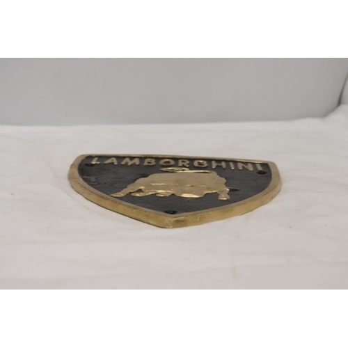 297 - A TRIANGULAR BLACK AND GOLD CAST METAL LAMBORGHINI SIGN, 21CM X 18CM