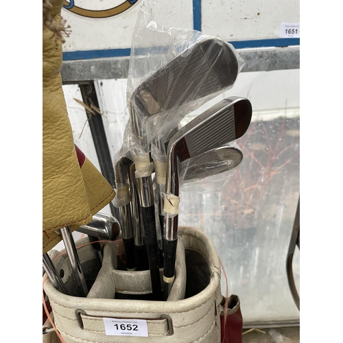 1652 - A VINTAGE GOLF BAG WITH AN ASSORTMENT OF GOLF CLUBS