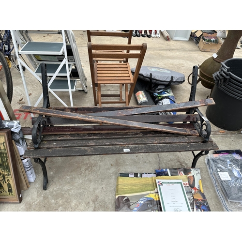 1959 - A WOODEN SLATTED GARDEN BENCH WITH CAST ENDS FOR RESTORATION