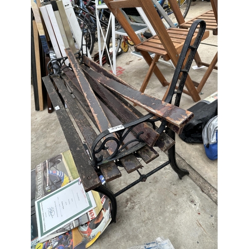 1959 - A WOODEN SLATTED GARDEN BENCH WITH CAST ENDS FOR RESTORATION