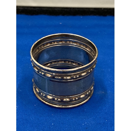 31 - THREE SILVER ITEMS TO INCLUDE TWO HALLMARKED BIRMINGHAM NAPKIN RINGS GROSS WEIGHT 59.67 GRAMS