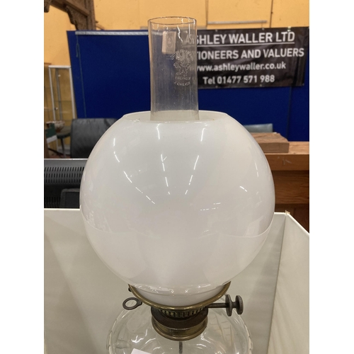 45 - A 19TH CENTURY OIL LAMP CONVERTED TO ELECTRIC WITH A BRASS BASE, CLEAR CUT GLASS RESERVOIR, MILK GLA... 