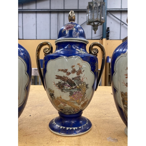 86 - THREE LARGE DECORATIVE ORIENTAL PIECES TO INCLUDE TWO VASE AND A TWIN HANDLED LIDDED URN