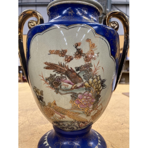 86 - THREE LARGE DECORATIVE ORIENTAL PIECES TO INCLUDE TWO VASE AND A TWIN HANDLED LIDDED URN